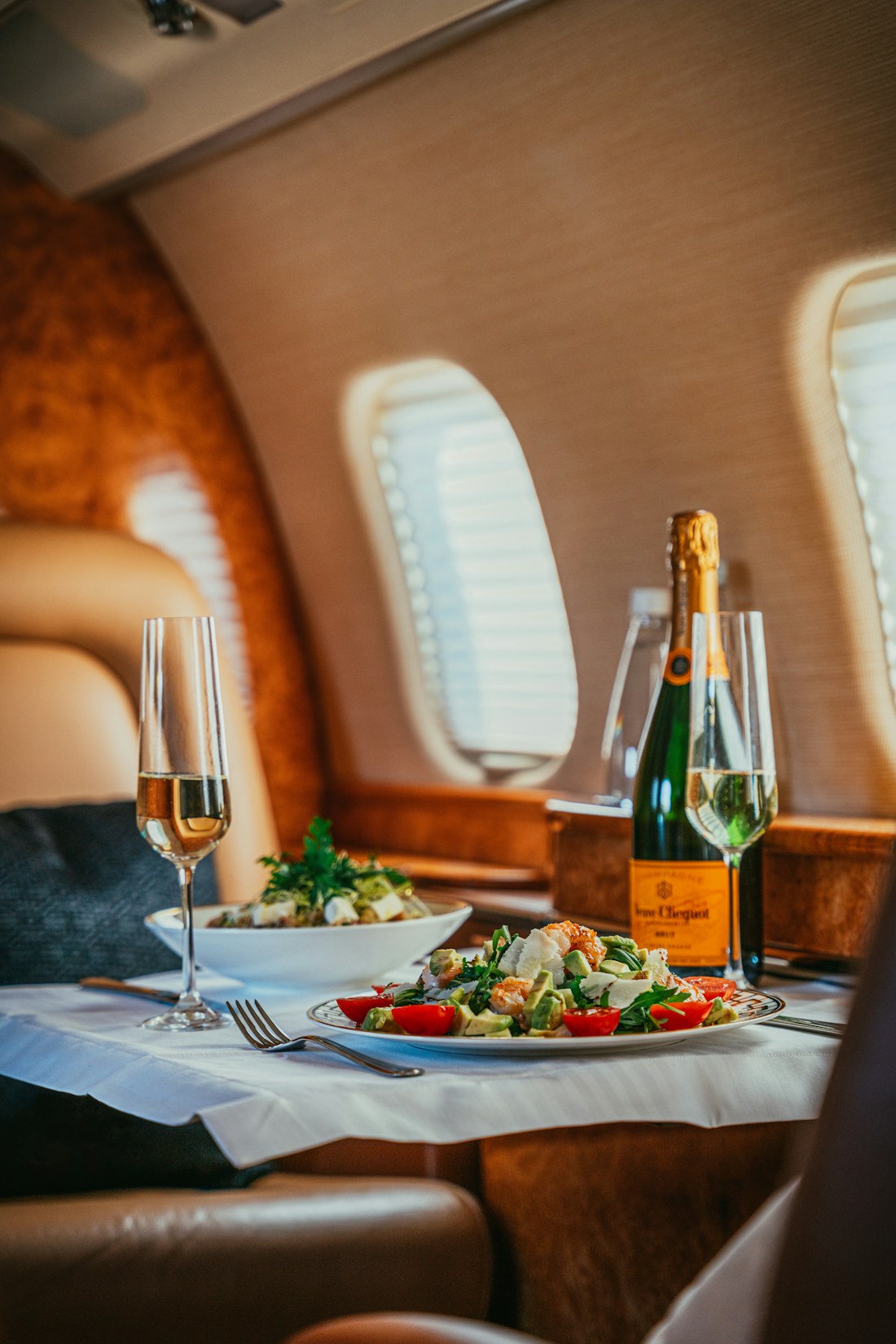 Champagne and fine dining aboard a private jet cabin