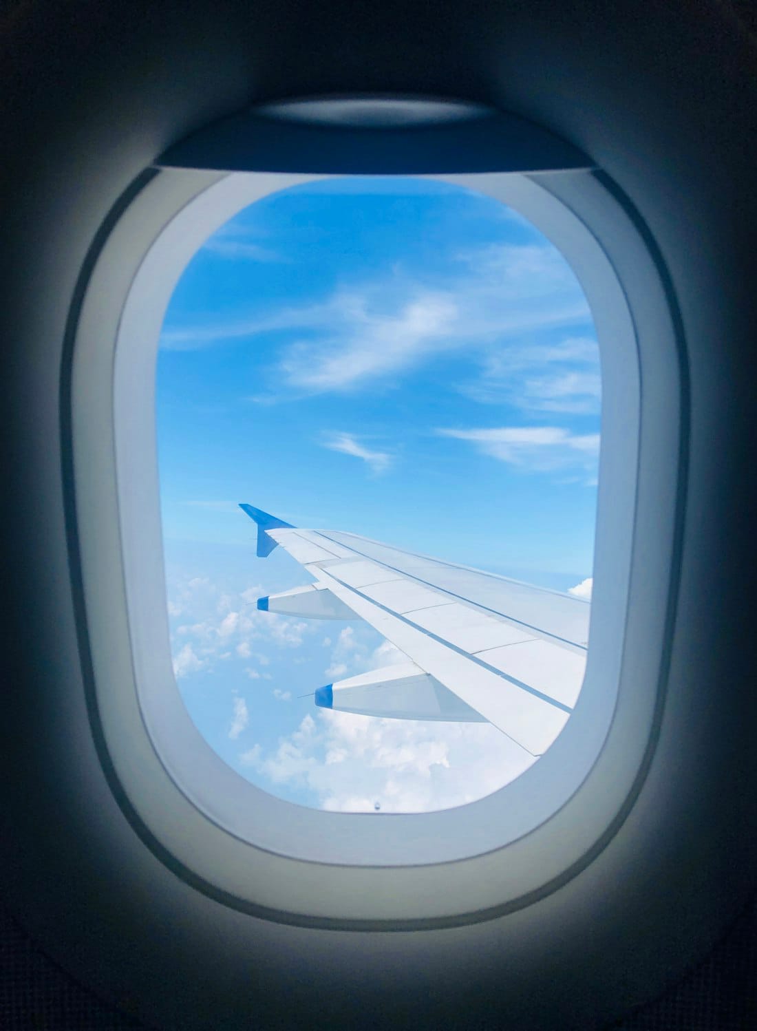 View over the wing and clouds from a jet window